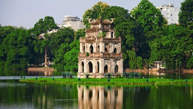 Travel to Ha Noi - Green calm lake surface with rows of old trees’ shade in Hoan Kiem Lake